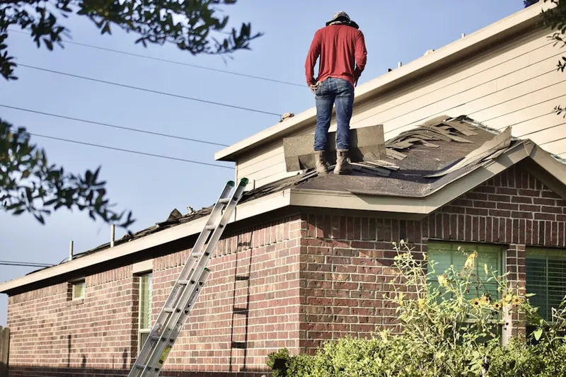 Professional roofer working on a residential roof in Fredericksburg